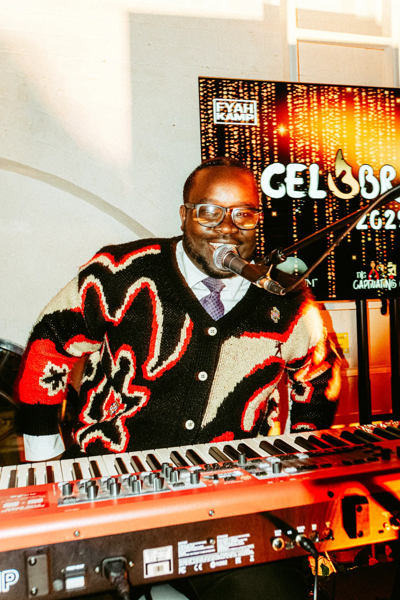 Musician performing at a keyboard and microphone at CEL3BRATION 2025